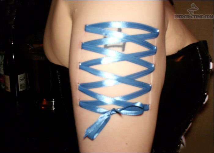 Corset Piercing With Blue Ribbons
